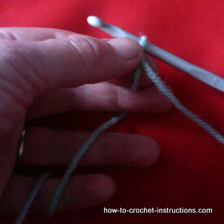 holding hook and yarn for crochet