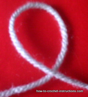 Begin a slip knot by crossing the yarn to make a loop